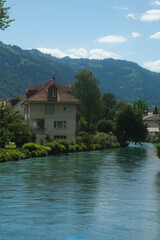 Fototapeta na wymiar A picture with noise effect of building in front of Aare river at Interlaken.