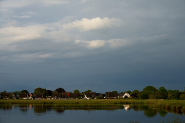 dark grey sky over a pond in Brake Unterweser, Germany