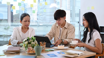 Team of professionals discussing project developing financial research, working together in modern office