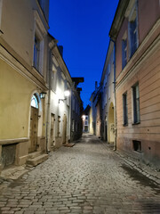 One of the narrow, cobbled streets of Old Tallinn against the blue sky. Spring evening.