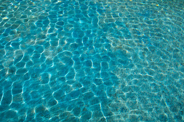 blue water surface with sun reflection