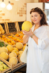beautiful caucasian woman buy fruits in vintage vegetable shop.