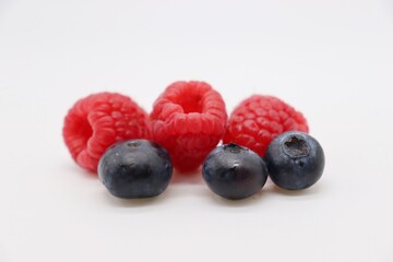 blueberries and raspberries on white background