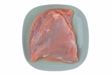 Turkey fillet in plate isolated in white background. Raw meat for cooking. Top view.