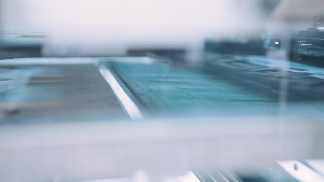 Close up, Automatic line for printing and cutting in the printing house.