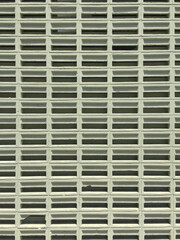 Front view of a series of light green concrete ventilation blocks