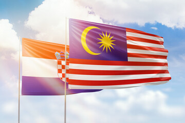 Sunny blue sky and flags of malaysia and croatia