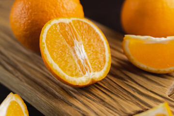 Fototapeta na wymiar Sliced oranges fruit on wooden board. Orange juicy fruit, citrus minimal concept