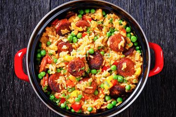 smoked sausages with rice and vegetables, top view
