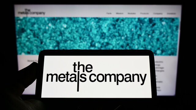 Stuttgart, Germany - 06-12-2022: Person holding smartphone with logo of mining company TMC The Metals Company Inc. on screen in front of website. Focus on phone display.