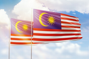 Sunny blue sky and flags of malaysia and malaysia