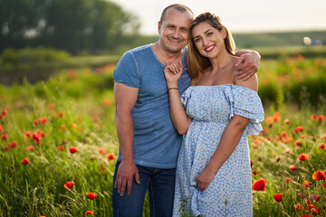 Mixed race couple in the poppy field