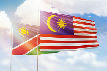 Sunny blue sky and flags of malaysia and namibia