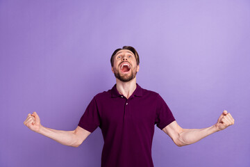 Photo of young excited guy fists hands yell winner awesome champion isolated over violet color...