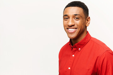 Headshot of friendly optimistic African-American guy in red shirt isolated on white. Smiling kind male student looking at the camera, portrait of employee