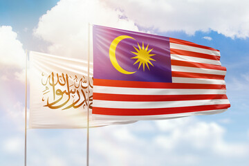 Sunny blue sky and flags of malaysia and afghanistan