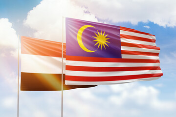 Sunny blue sky and flags of malaysia and yemen