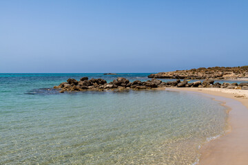 Fototapeta na wymiar The beautiful turquoise water and natural breakwaters at Neve Yam public beach in Atlit Israel 