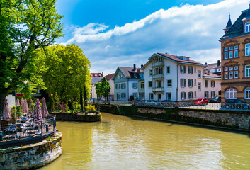 Germany, Houses of esslingen am neckar city in summer with blue sky and sun next to neckar river water, a tourism destination