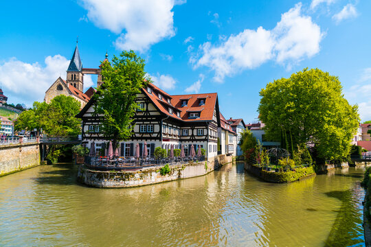 Germany, Old town houses of esslingen am neckar city in summer with blue sky and sun next to neckar river water, a tourism destination