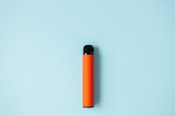 One disposable orange e-cigarettes. Concept of bad habits, modern smoking electronic cigarettes.