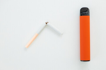 Color disposable electronic cigarettes and regular nicotine cigarette on a white background. choice...