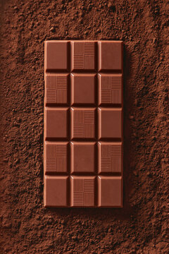 Chocolate Bar On A Cocoa Background Viewed From Above. Top View