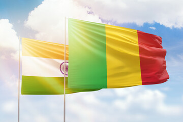 Sunny blue sky and flags of mali and india
