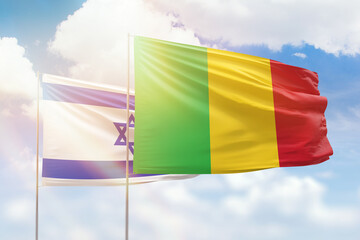 Sunny blue sky and flags of mali and israel