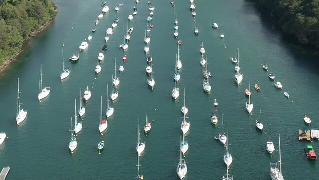 Wide aerial view over moored boats on the River Fowey, Cornwall, UK