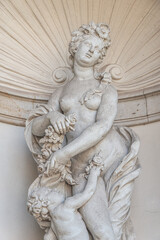 Old sculpture of a sensual woman nymph bathing at the fountain in Zwinger gardens at historical and...