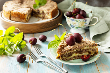 Homemade summer pastry gluten free. Chocolate and cottage cheese pie with cherries on a rustic table.
