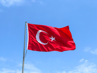 turkish flag wawing in the air or over blue sky in a sunny day in Turkey