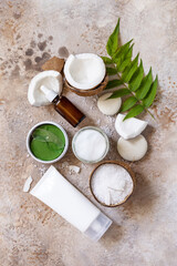 Natural organic cosmetics with coconut butter for body care, spa treatment. Сoconut oil, bath salt, cosmetic cream, serum and hydrogel eye patches. View from above.