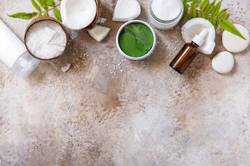 Natural organic cosmetics with coconut butter for body care, spa treatment. Сoconut oil, bath salt, cosmetic cream, serum and hydrogel eye patches. View from above. Copy space.