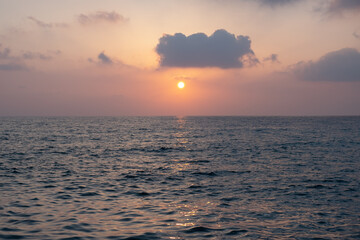 Obraz premium Dusk sunset on a dramatic cloudy sky over the Mediterranean sea. Sea with waves.Magic Tranquil seascape.