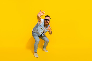 Photo of funny handsome guy dressed denim vest rising dark glasses hands arms dancing isolated...