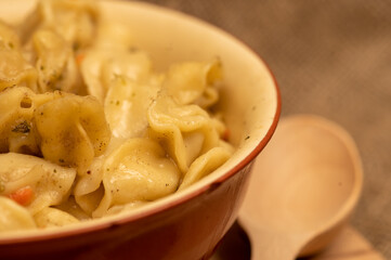 Boiled with spices dumplings with meat in a ceramic bowl. Close-up, selective focus
