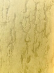 a yellowish wall with stains