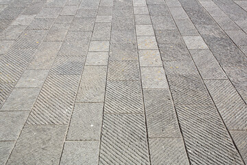 New carved paving made with chiseled grey sandstone blocks in a pedestrian zone