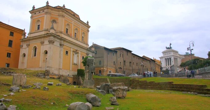 Low angle shot of area in front of Theatre of San Marcellus surrounded by old historical buildings in Rome, Italy at daytime.