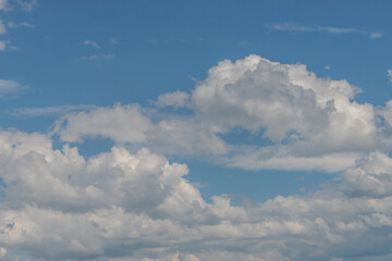 Cover page with soft blue sky with illuminated clouds as a background.