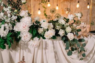 Beautiful groom and bride table decorated with natural materials and a lot of flowers