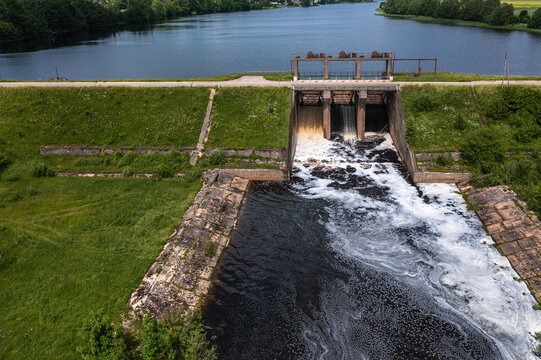 Aerial view of a small old dam on the river in summer