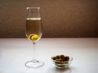 A glass of dry sherry and olives