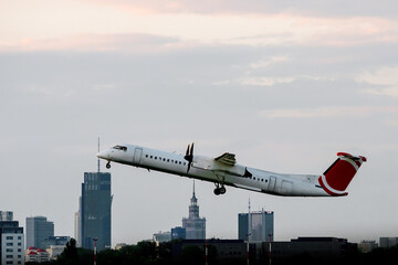 The big passenger plane takes off at the city airport.