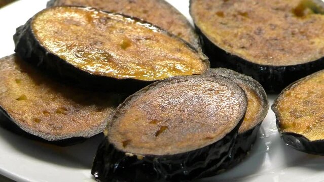 Fry eggplants in a frying pan in oil. Cooking Vegetarian vegetable food.