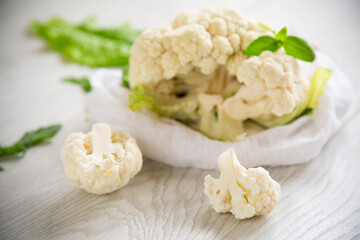 inflorescences of small cauliflower on a light wooden table