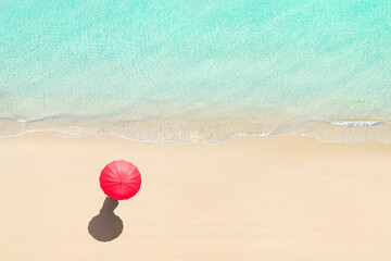 Fototapeta na wymiar Top view of woman with red summer umbrella walking tropical Seychelles sand beach. Blue, turquoise transparent water surface of ocean, sea, lagoon. Aerial, drone view