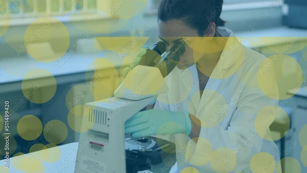 Poster animation of dots floating over biracial female lab worker using microscope